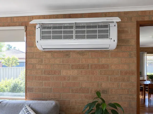 Clean split system mounted high on a brick wall in a suburban living room in Elizabeth South